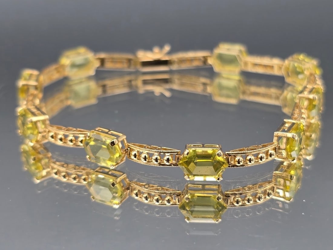14K Peridot Geometric Tennis Bracelet: A 14K yellow gold tennis bracelet with nine hexagonal cut peridots alternating with beaded gold links. Marked 14K. 7-1/2in long. 5.59 dwt. | You have additional shipping options, and are not required 