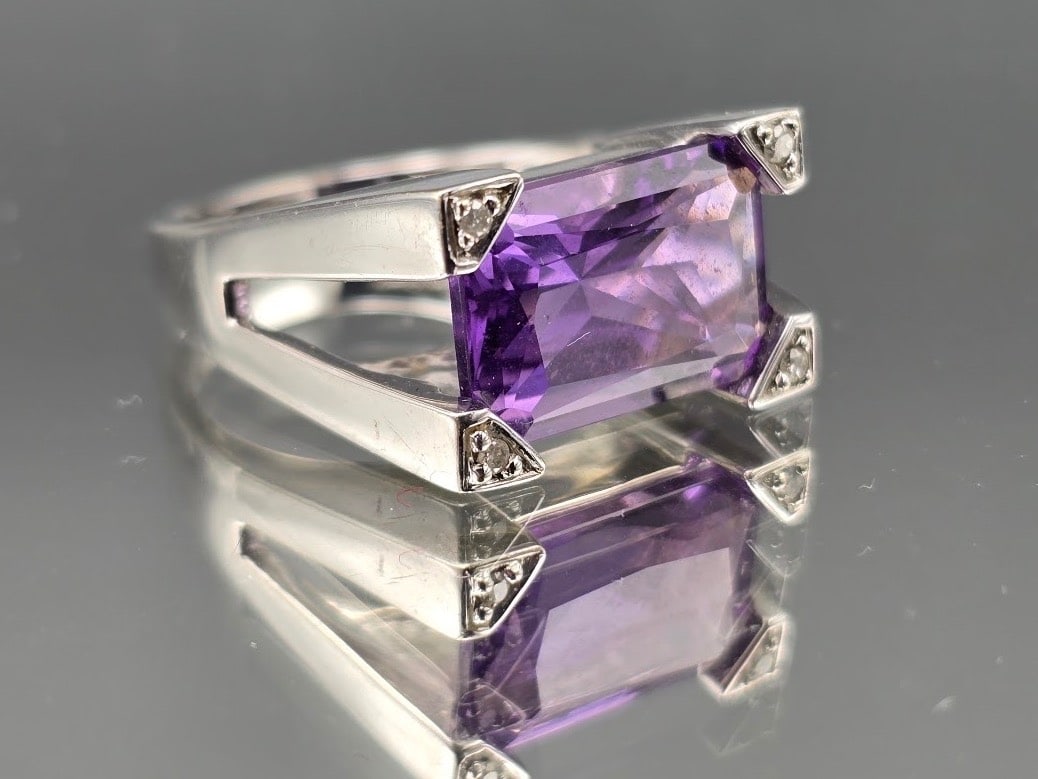 14K Art Deco-style Amethyst and Diamond Ring: A 14K white gold Art Deco-style ring with a rectangular cut amethyst flanked by four diamonds. Marked 14K. Ring size 7. 5.01 dwt. | You have additional shipping options, and are not required to use
