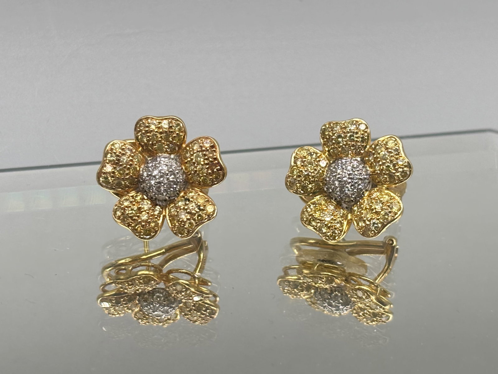 18K Pave Diamond Flower Earrings: A pair of 18K yellow gold flower form earrings with yellow and white pave diamonds. 3/4in diameter. 6.75 dwt. | You have additional shipping options, and are not required to use Live Shipping. Additio