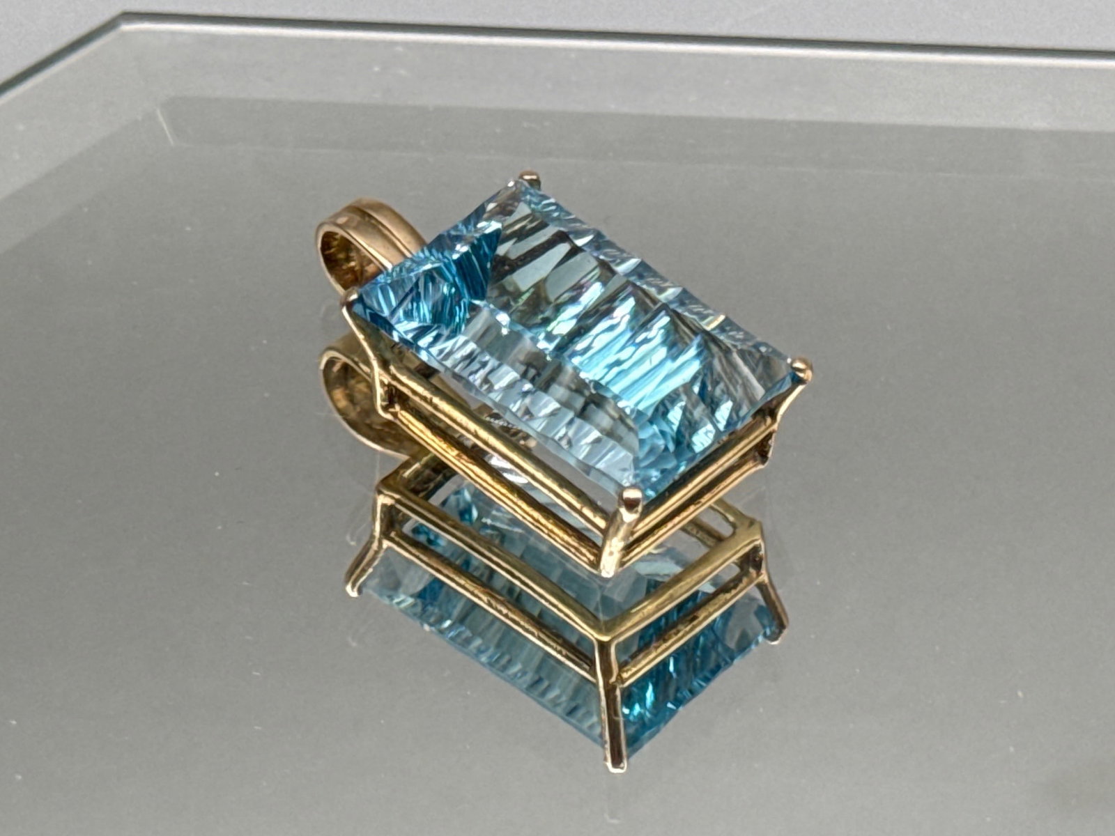 14K Pendant with Emerald Cut Blue Topaz: A 34.8ct emerald cut blue topaz pendant set in 14K yellow gold. 1-1/2in tall x 3/4in wide. 7.26 dwt. | You have additional shipping options, and are not required to use Live Shipping. Additional
