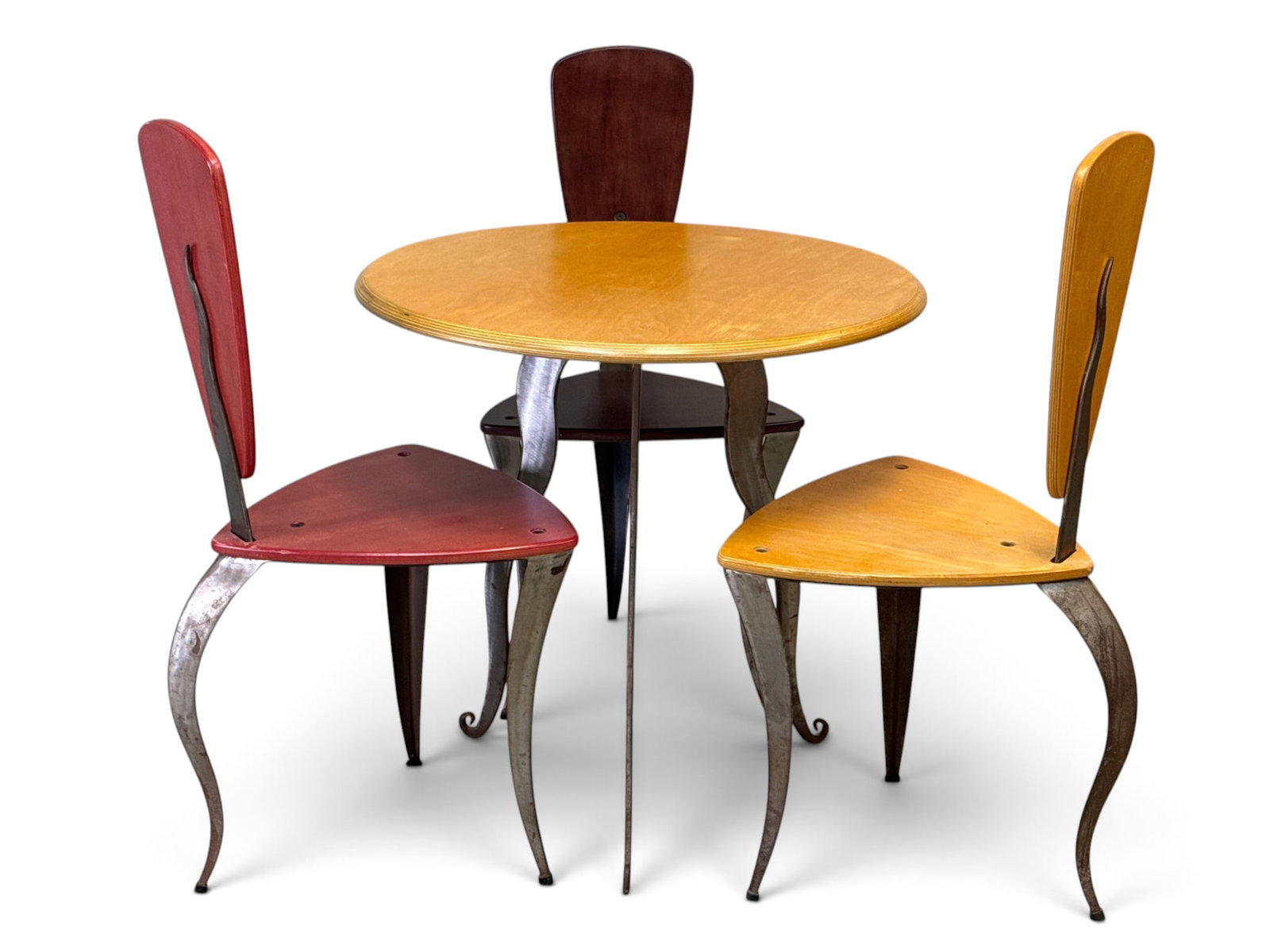 Artisan Studio Bistro Dinette Set: An artisan studio bistro dinette set comprised of a table and three chairs with wavy spine supported backs, all on steel legs. Unsigned. Table: 29in tall x 29in wide. | You have additional shipping