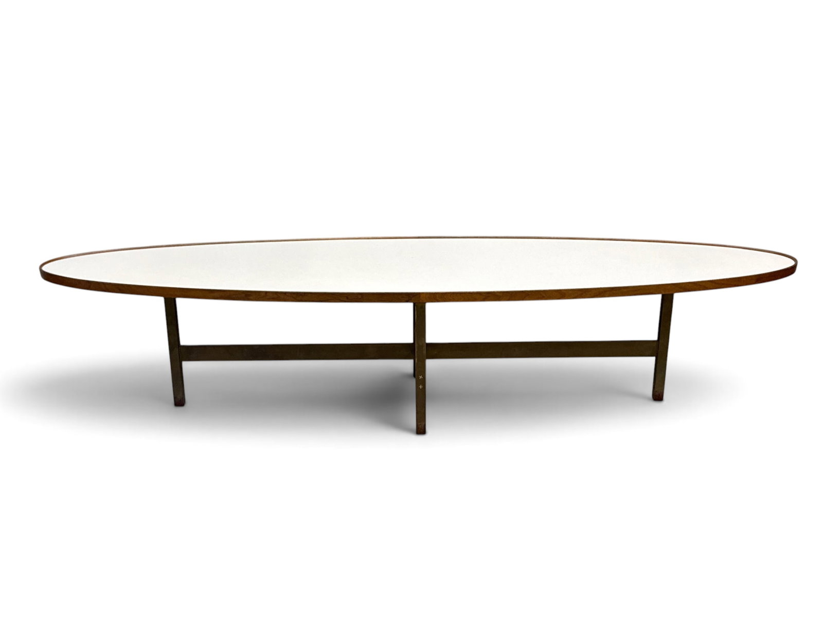 Edward Wormley for Dunbar Elliptical Coffee Table: An Edward Wormley for Dunbar midcentury modern elliptical coffee cocktail table with a white laminated top and walnut gallery, over brass legs with walnut-capped feet. Labeled. 15-1/2in tall x 72in