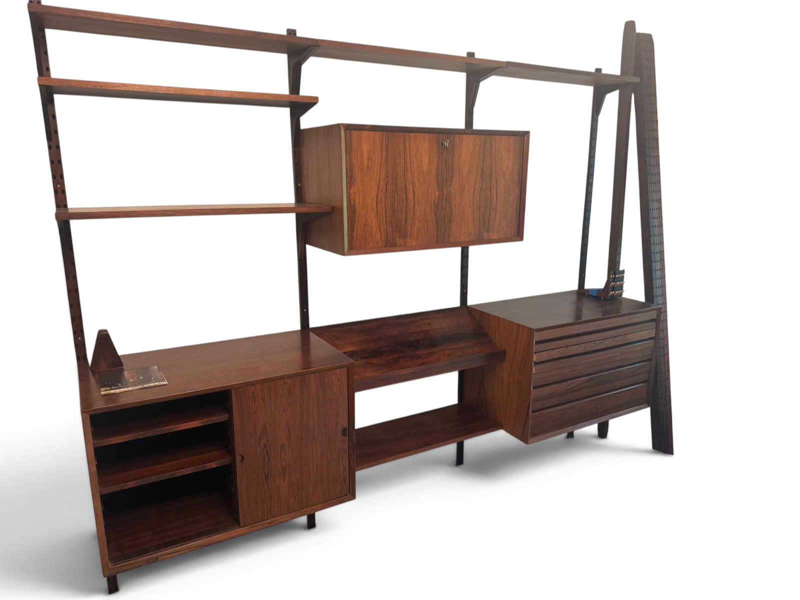 Poul Cadovius Rosewood Wall Unit: A Poul Cadovius Danish modern rosewood CADO wall unit comprised of three cabinets, 13 shelves, and eight uprights. | You have additional shipping options, and are not required to use Live Shipping.