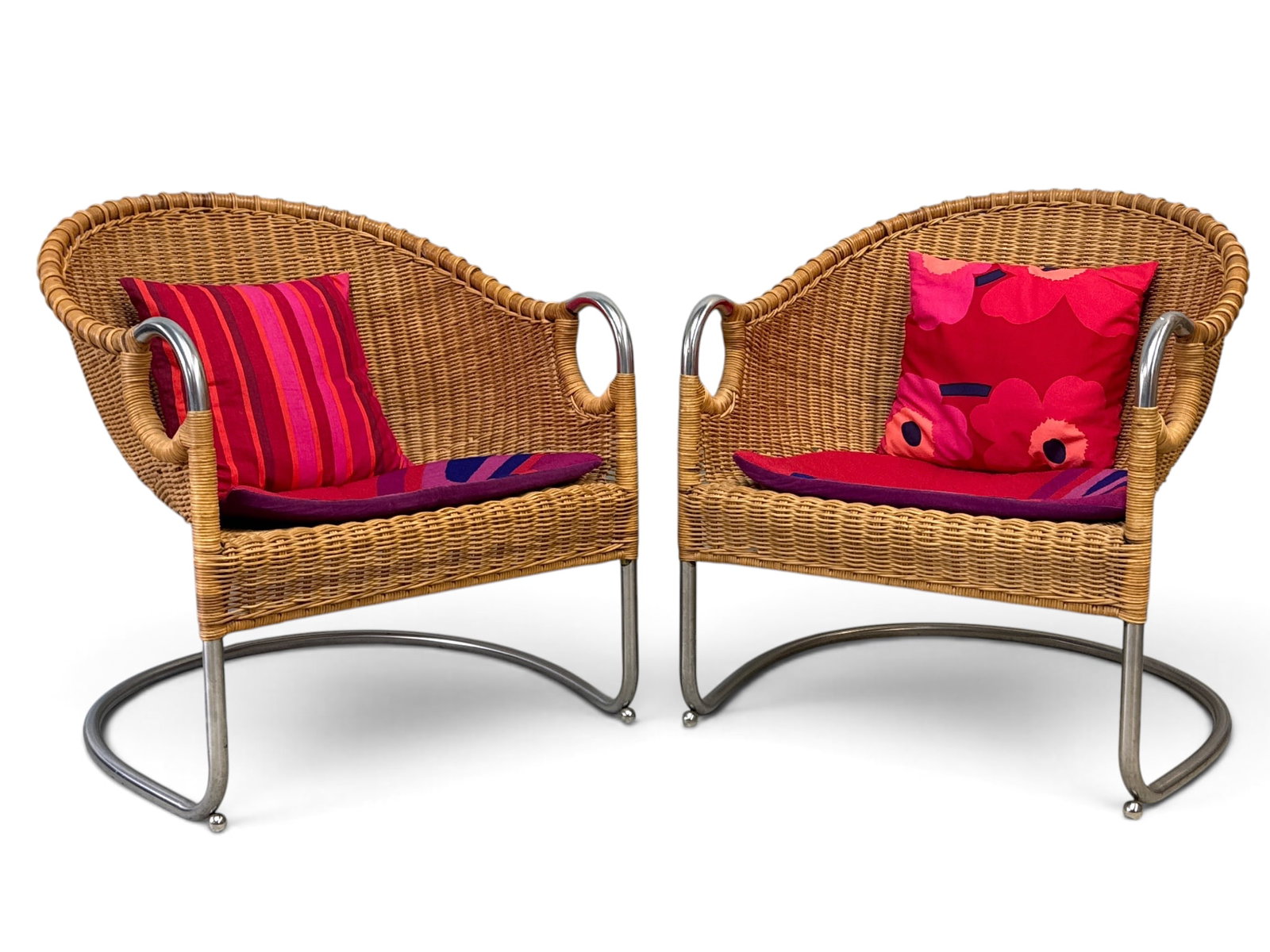 Pair of Harvey Probber-style Chrome and Wicker Chairs: A pair of modern design tubular chrome and wicker barrel back cantilever lounge chairs in the manner of Harvey Probber. Unsigned. 30in tall x 27in wide x 27in deep. | You have additional shipping