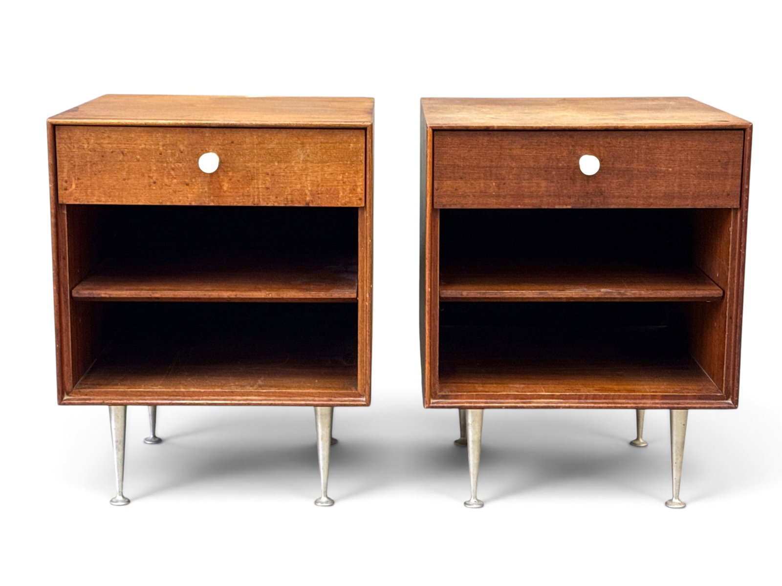 Pair of George Nelson Thin Edge Nightstands: A pair of George Nelson for Herman Miller "Thin Edge" walnut nightstands with single drawers and adjustable shelves. Unmarked. Pulls are contemporary reproductions. 23-1/2in tall x 18in wide x 20in de