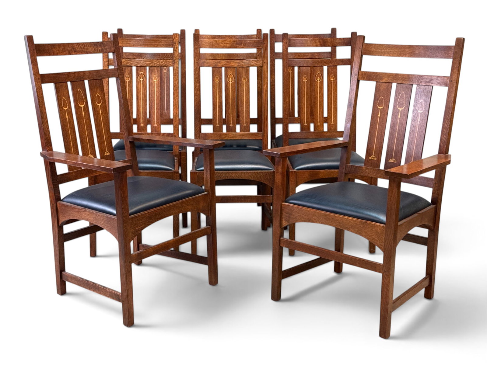 Eight Stickley Harvey Ellis Oak Dining Chairs: A set of eight contemporary Stickley Arts & Crafts oak dining chairs, comprised of two armchairs and six side chairs. Armchairs: 43-3/4in tall x 26in wide x 19in deep. | You have additional shipping o