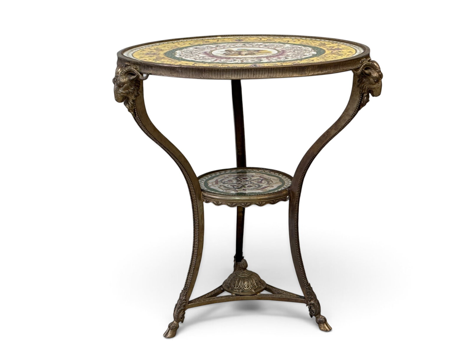 Neoclassical-style Porcelain-Mounted Gueridon Table: A Neoclassical-style gueridon table with porcelain mounts, featuring an ornate cast bronze tripod base on hoof feet with ram's head mounts. The round porcelain top and matching lower tier display intr