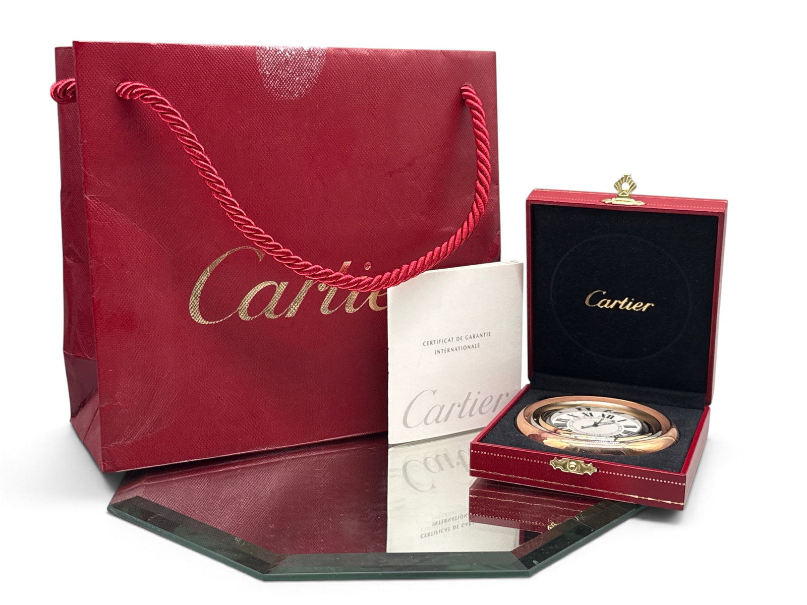 Cartier Trinity Desk Clock: A Cartier Trinity desk clock with concentric-circle form. Marked Cartier on face and back. Includes original box, bag and paperwork. Clock: 3in diameter. | You have additional shipping options, and ar