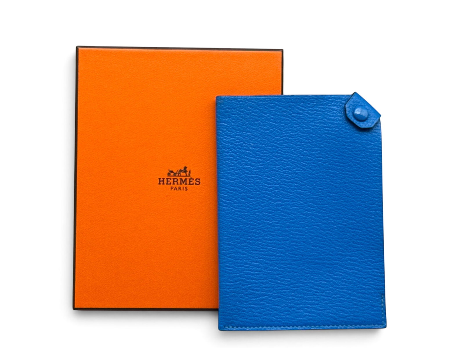 Hermes Tarmac Leather Passport Holder: An Hermes Tarmac pebbled leather passport holder in a vibrant blue. Marked Hermes verso. Includes original Hermes box. 5-1/2in tall x 4in wide. | You have additional shipping options, and are not requ
