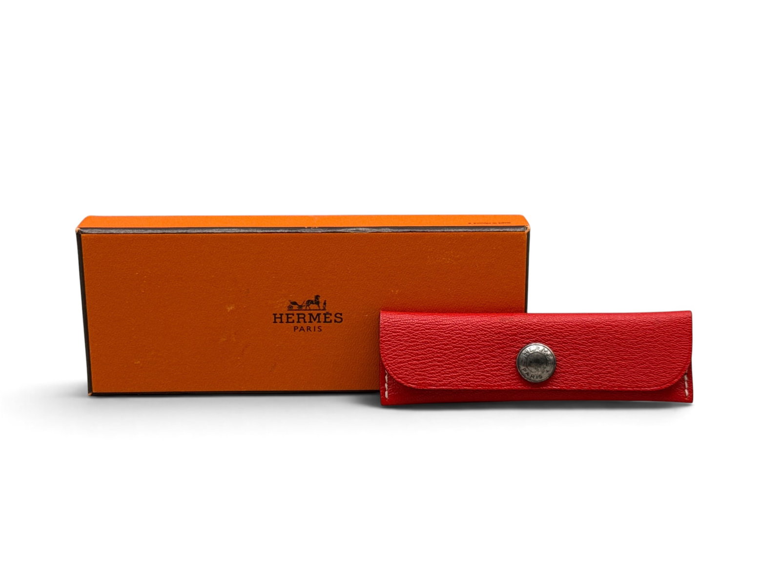 Hermes Horn Comb and Leather Case: An Hermes Paris comb in horn with a poppy red leather comb case with Hermes snap closure. Includes original Hermes box. Case: 1-3/8in tall x 4-1/4in wide. | You have additional shipping options, and a