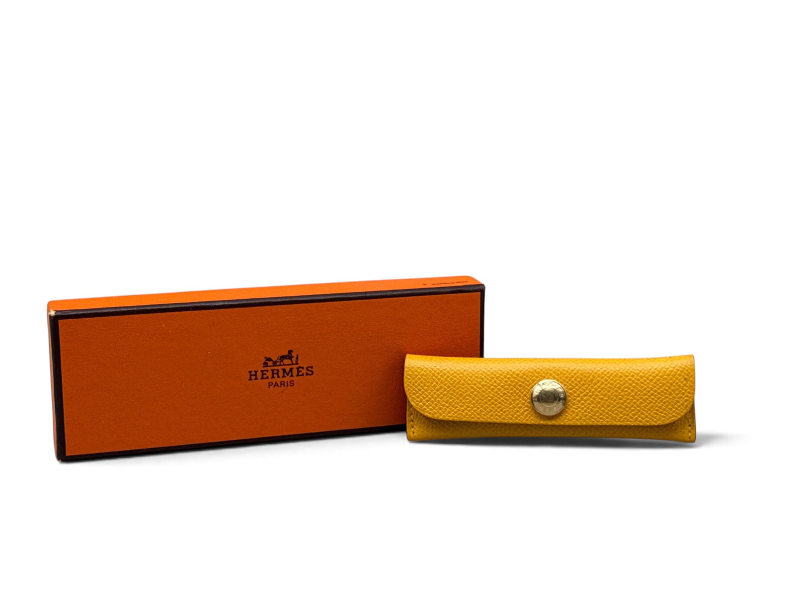 Hermes Horn Comb and Case: An Hermes Paris comb in horn with a poppy red leather case with Hermes snap closure. Includes original Hermes box. Case: 1-3/8in tall x 4-1/4in wide. | You have additional shipping options, and are no