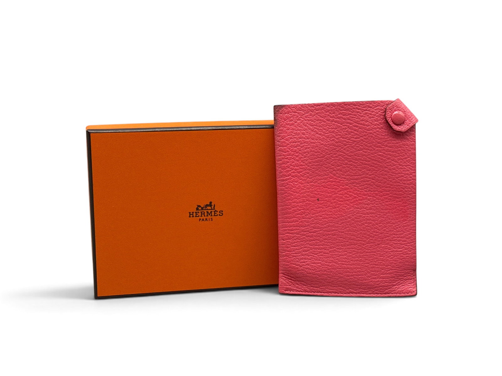 Hermes Pink Tarmac Passport Holder: An Hermes pink leather Tarmac passport holder. Marked Hermes verso. Includes Hermes box. 5-3/4in tall x 4in wide. | You have additional shipping options, and are not required to use Live Shipping. Add