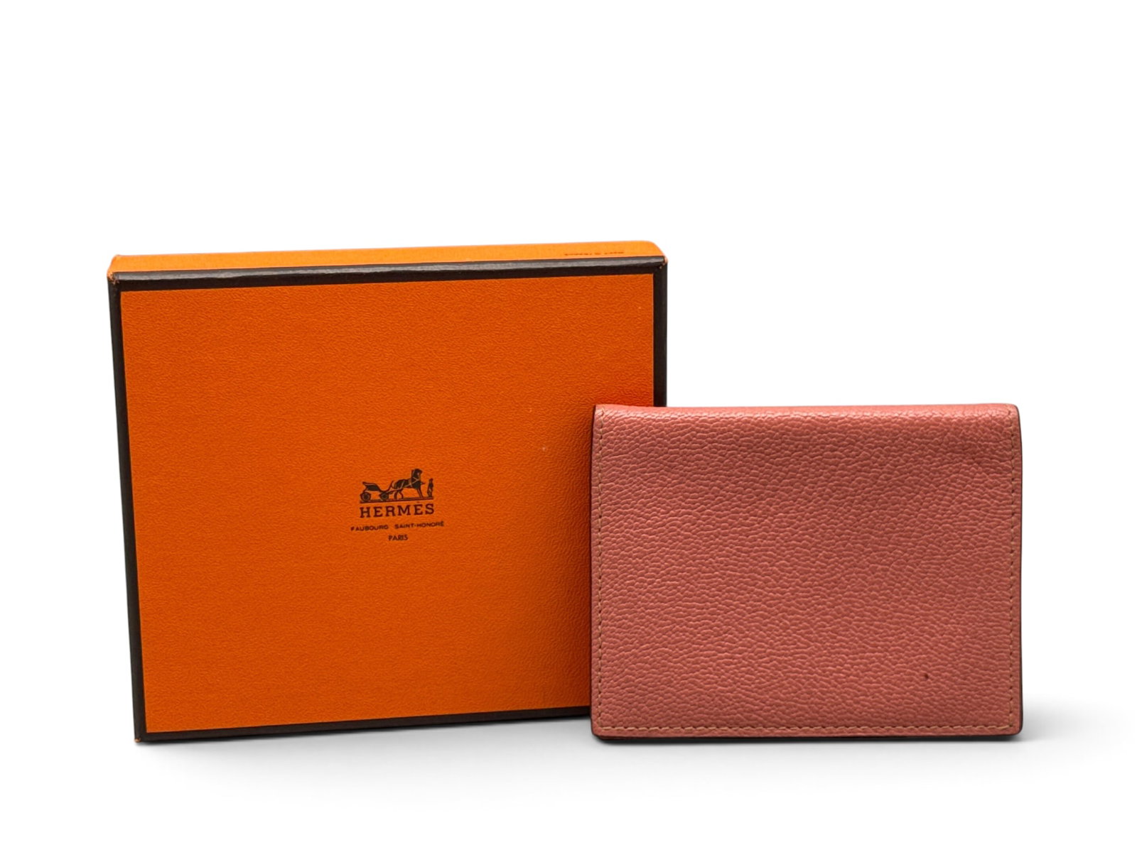 Hermes Pink Leather PM Agenda Cover: An Hermes pink leather PM agenda cover with two pocket interior with hooks for date book. Marked Hermes on interior. Includes Hermes box. 4in tall x 3in wide. | You have additional shipping options, a