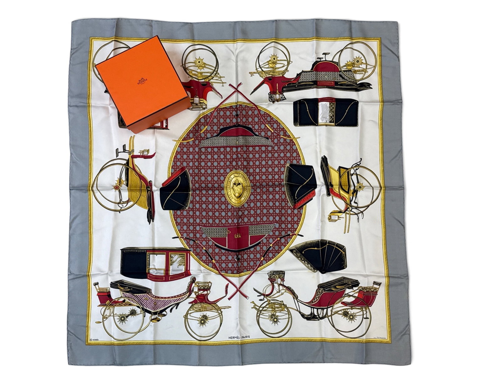 Hermes Paris Les Voitures A Transportation Scarf: An Hermes Paris Les Voitures A Transportation silk scarf with carriage motif. Marked Hermes Paris. Includes orange Hermes gift box. 34in tall x 33-1/2in wide. | You have additional shipping options, a