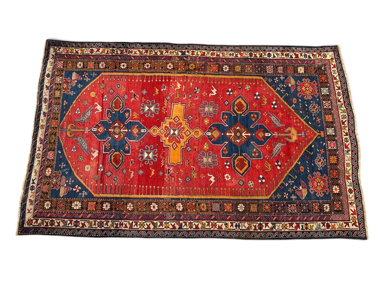 Hand-Knotted Caucasian Carpet, 6ft 11in x 4ft 4in: A hand-knotted Caucasian area carpet with a medallion design and birds. 6ft 11in x 4ft 4in. | You have additional shipping options, and are not required to use Live Shipping. Additional shipping and d