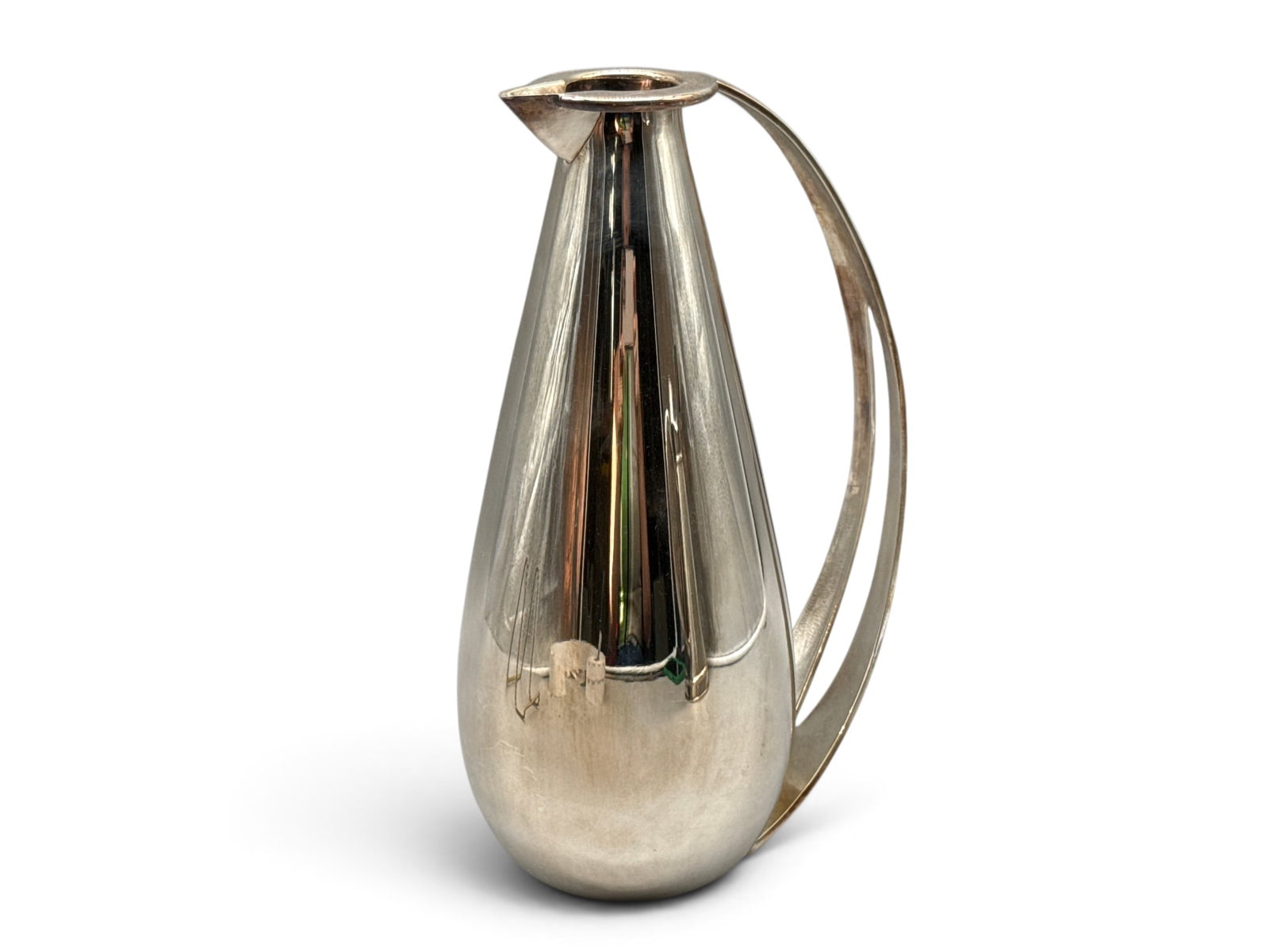 Hermes Modernist Water Pitcher: An Hermes Paris silver plated water pitcher of modernist, tapered form with openwork handle and rimmed mouth. Marked Hermes. 11in tall x 6in wide. | You have additional shipping options, and are not r