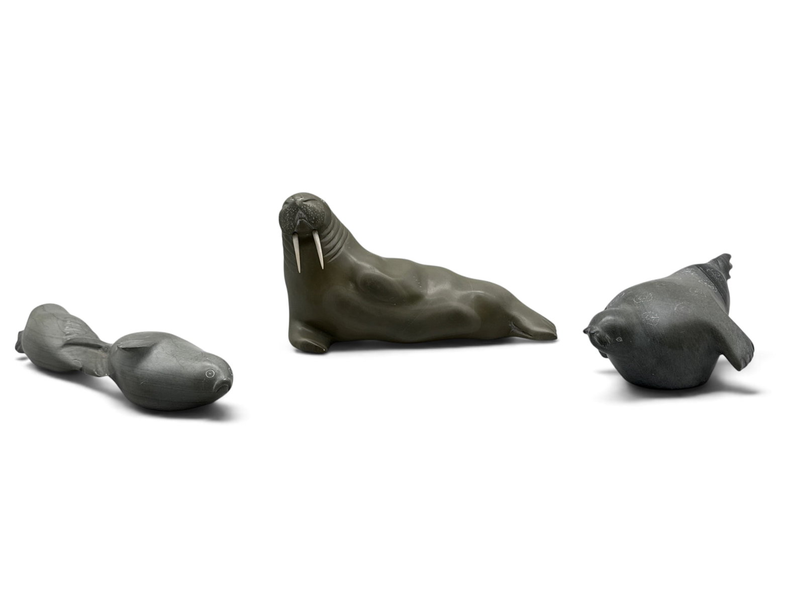 Three Inuit Carved Stone Seals and Walruses: A grouping of three Inuit carved stone seals and walrus figures. Largest: 5in tall x 9in wide. | You have additional shipping options, and are not required to use Live Shipping. Additional shipping an