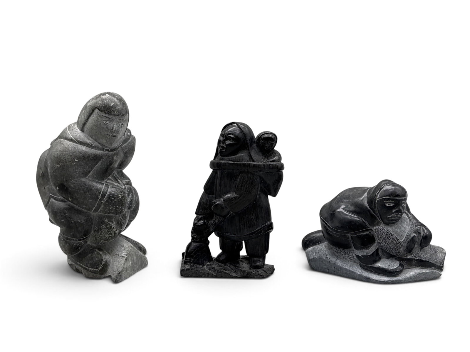 Three Inuit Carved Stone Figures: A grouping of three Inuit carved stone figures. Largest signed Isapik Smith. Largest: 8-1/4in tall. | You have additional shipping options, and are not required to use Live Shipping. Additional shippi
