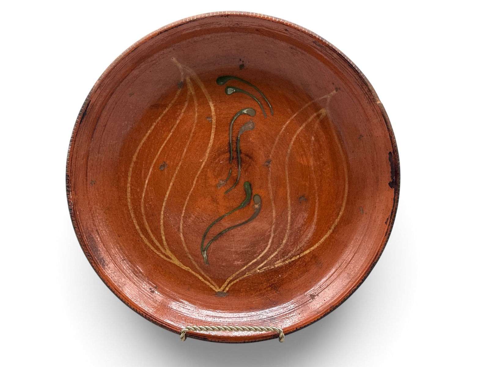 19th C. Slip Decorated Redware Plate: A 19th C. redware plate with yellow and green slip decoration in tulip-form. Signed "C" verso. 11in diameter. | You have additional shipping options, and are not required to use Live Shipping. Additio