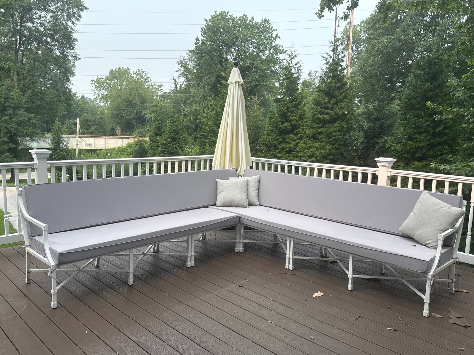Decorator Aluminum Outdoor Two-Piece Sectional: A white two-piece sectional sofa in coated aluminum with a Chippendale-style fretwork back and Detiblue cushions. 31-1/2in tall x 107in long per chaise. Total length: 214 in. | You have additional shi