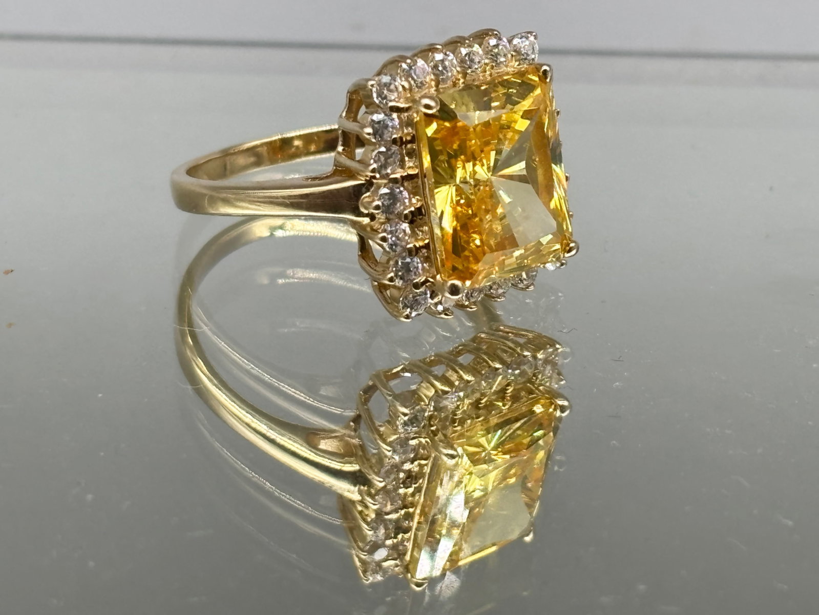 14K Citrine and Diamond Ring: A 14K yellow gold ring with a rectangular cut citrine surrounded by a halo of diamonds. Size 9. 4.43 dwt. | You have additional shipping options, and are not required to use Live Shipping. Additional