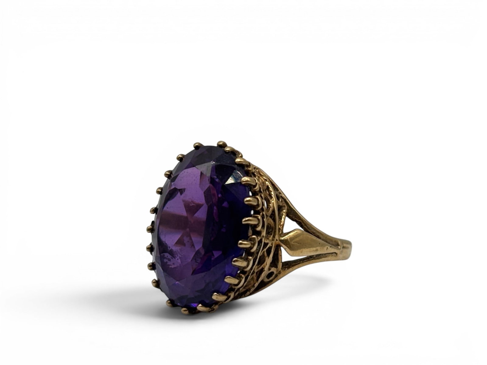 14K Color-Change Sapphire Ring: A 14K yellow gold ring with filigree raised mount, set with an oval cut color-change sapphire. Ring size 6-1/2. 6.04 dwt. | You have additional shipping options, and are not required to use Live