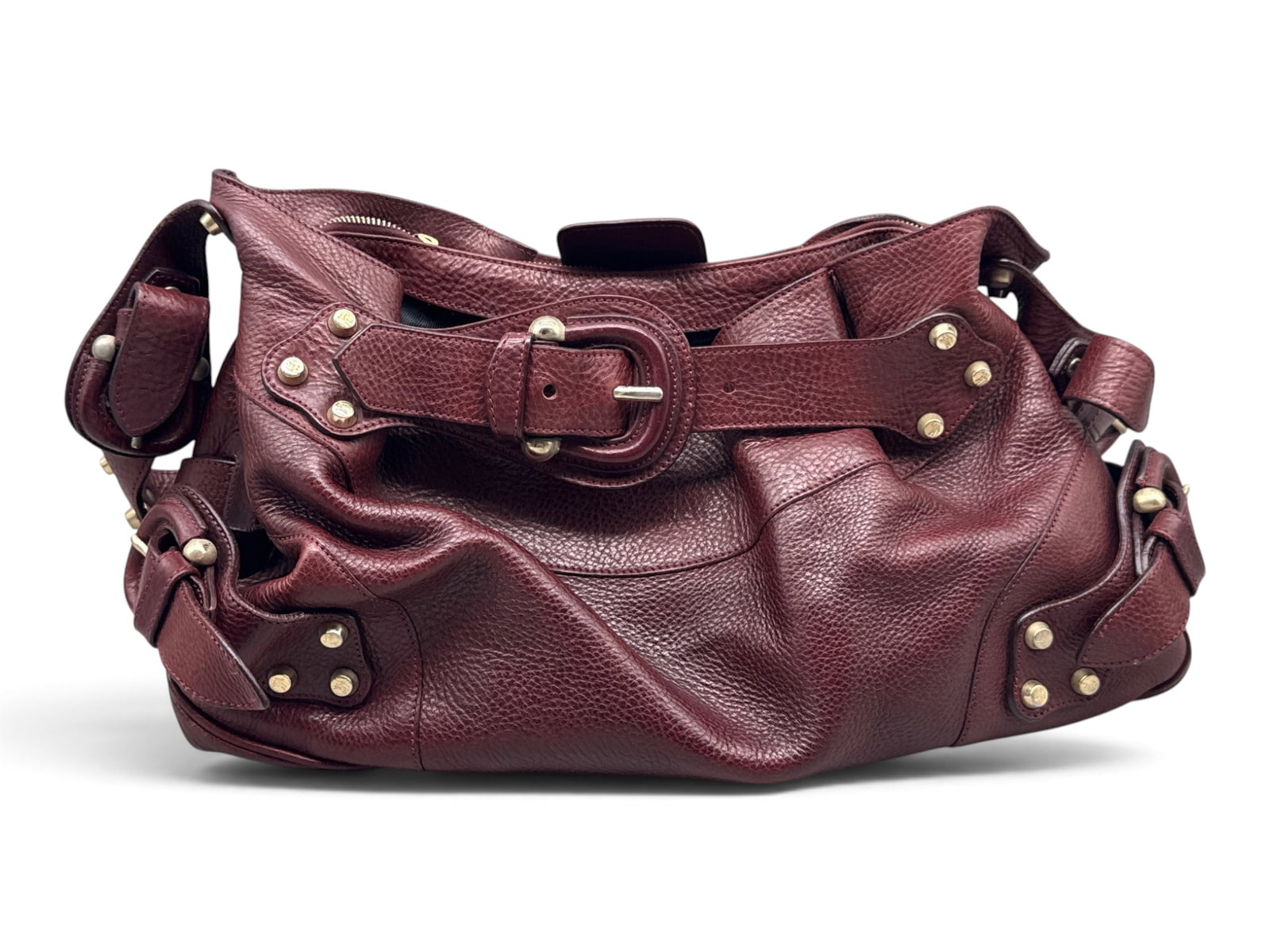 Burberry Burgundy Leather Shoulder Bag: A Burberry burgundy leather slouchy shoulder bag with Burberry logo, gold-tone grommet hardware throughout, and leather buckle closure. Interior is marked Burberry. 9in tall x 13in wide. | You have ad