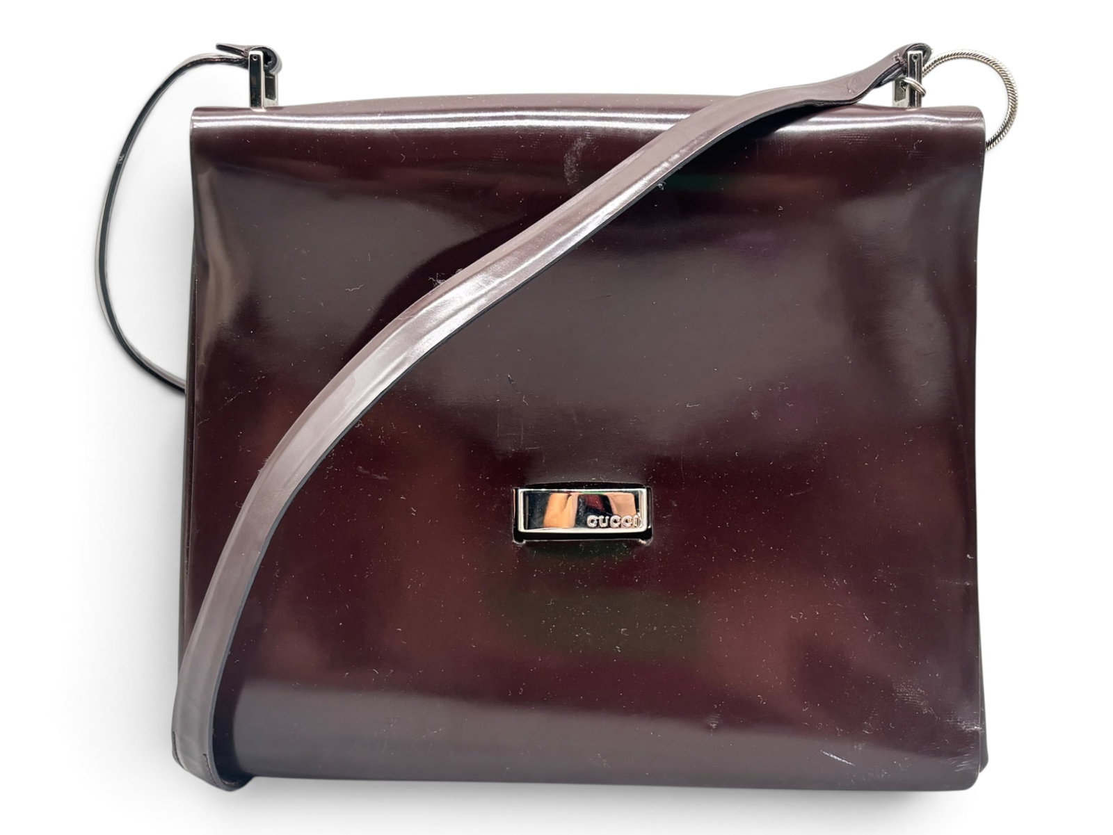 Gucci Burgundy Patent Leather Shoulder Bag: A Gucci burgundy patent leather shoulder bag with monogrammed chrome hardware and Gucci label in the interior with serial number. Includes Gucci dust cloth. 9in tall x 11in wide. | You have additional