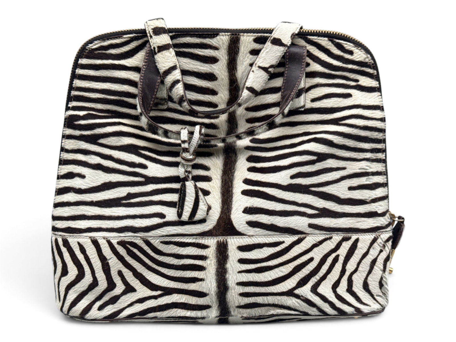 Prada Zebra Print Calf-Hair Top Handle Bag: A Prada calf-hair zebra print bag with top handle, gold-tone zip-lock closure and logo printed jacquard interior lining. Key is present. Includes original certificate of authenticity, number B4244. 12