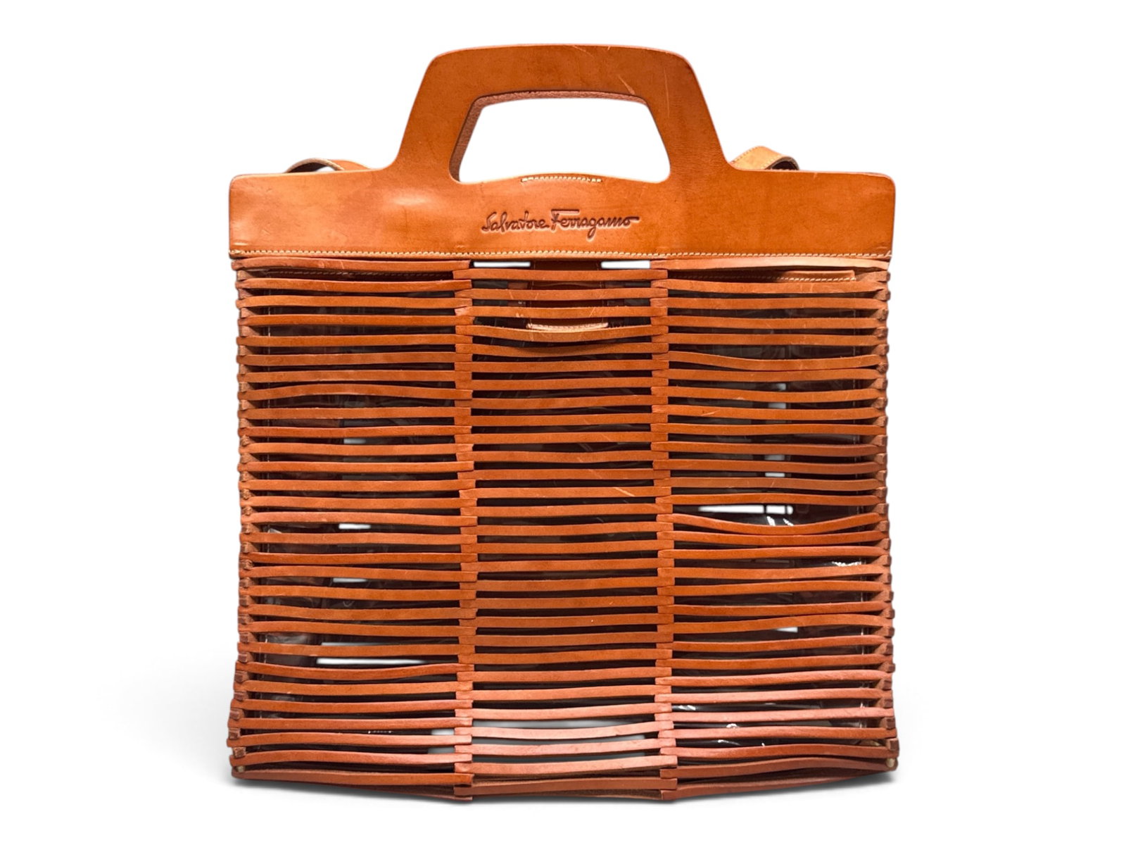 Salvatore Ferragamo Cage Leather Tote: A Salvatore Ferragamo cage-leather tote with logo engraved leather handles and slatted leather body. Interior has a clear PVC lining. Includes cross-body strap, original tag, and Salvatore Ferragamo d