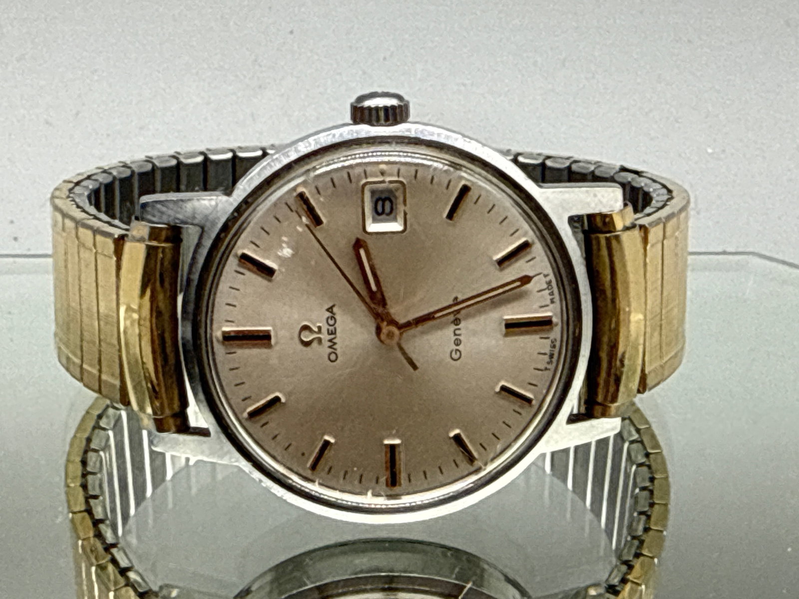 Omega Geneve Date Watch: An Omega Geneve Date watch with stainless steel face and gold- and silver-tone Speidel expandable bracelet. 2-1/2in diameter. | You have additional shipping options, and are not required to use Live
