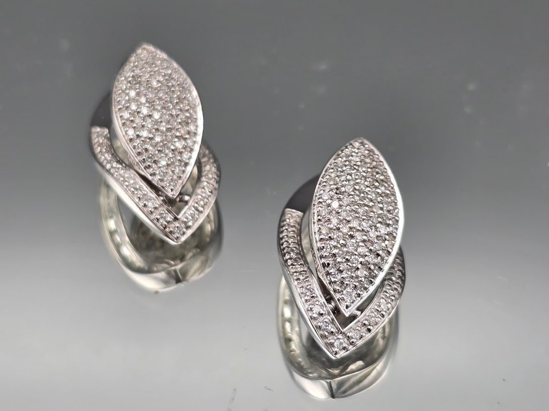 14K Pave Diamond Teardrop Earrings: A pair of 14K white gold earrings of almond form with pave diamonds. Marked 14K. 3/4in tall x 1/2in wide. 3.27 dwt. | You have additional shipping options, and are not required to use Live Shipping.