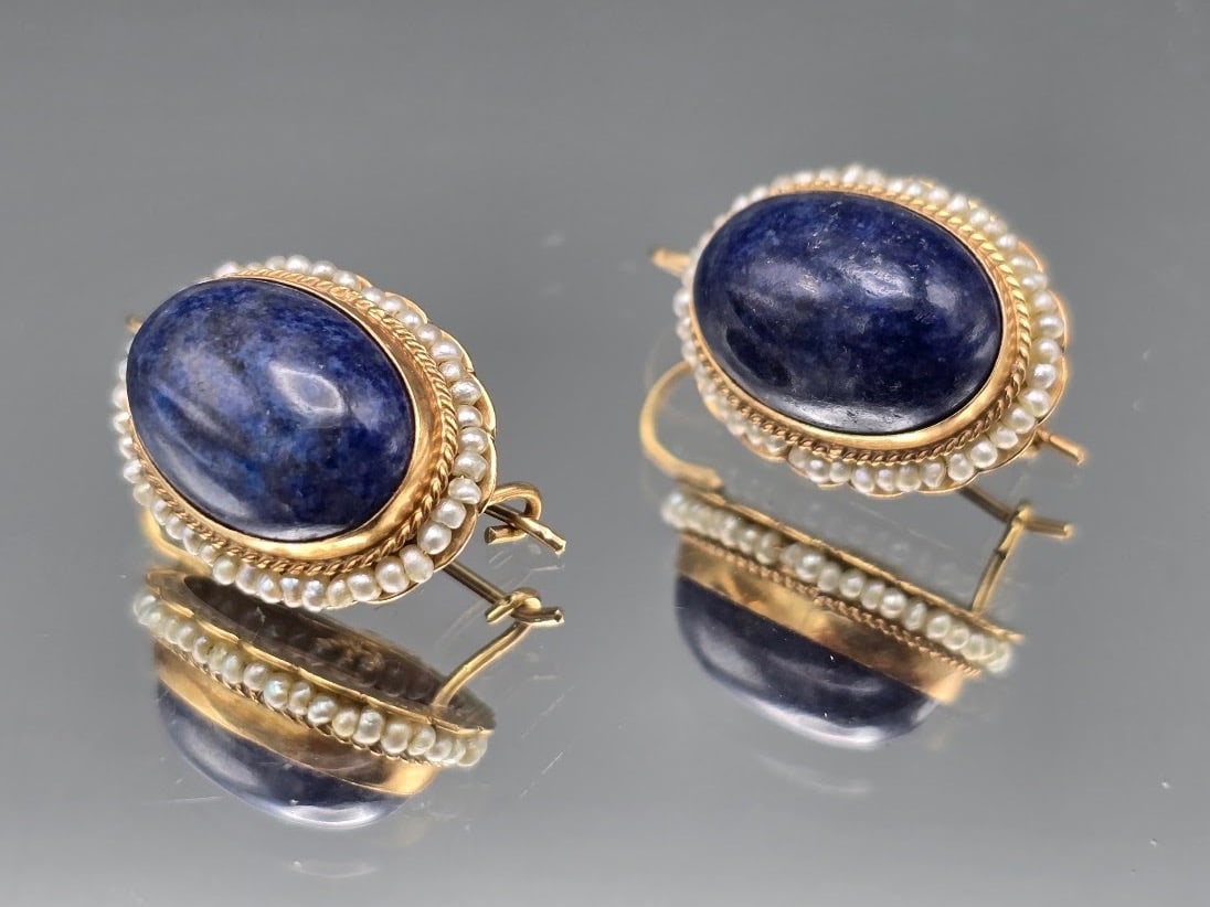 14K Lapis and Seed Pearl Earrings: A pair of 14K yellow gold earrings with oval lapis cabochons surrounded by seed pearls. Marked 14K. 7/8in tall x 1/2in wide. 3.27 dwt. | You have additional shipping options, and are not required to