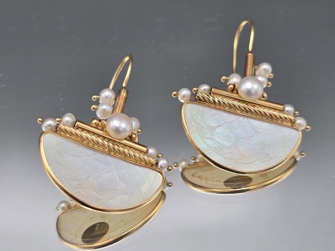 Donna Chambers 14K Mother of Pearl Earrings: A pair of Donna Chambers 14K yellow gold and mother-of-pearl half round Chinese gaming chip earrings with pearl decoration. Marked 14K and hallmarked "DC". 1in tall x 1in wide. 3.6 dwt. | You have