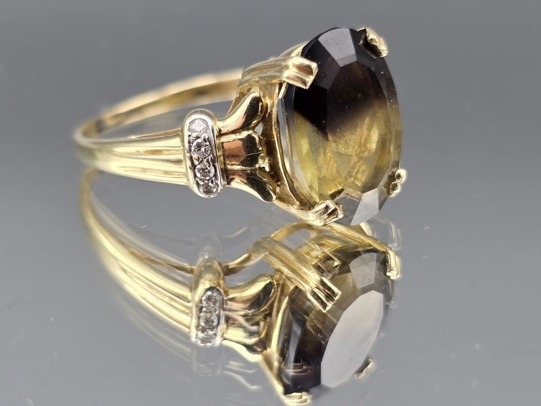14K Smoky Topaz and Diamond Ring: A 14K yellow gold ring with oval cut smoky topaz flanked by lobed shoulders with diamond accents. Marked 14K. Size 8-1/2. 3.4 dwt. | You have additional shipping options, and are not required to use
