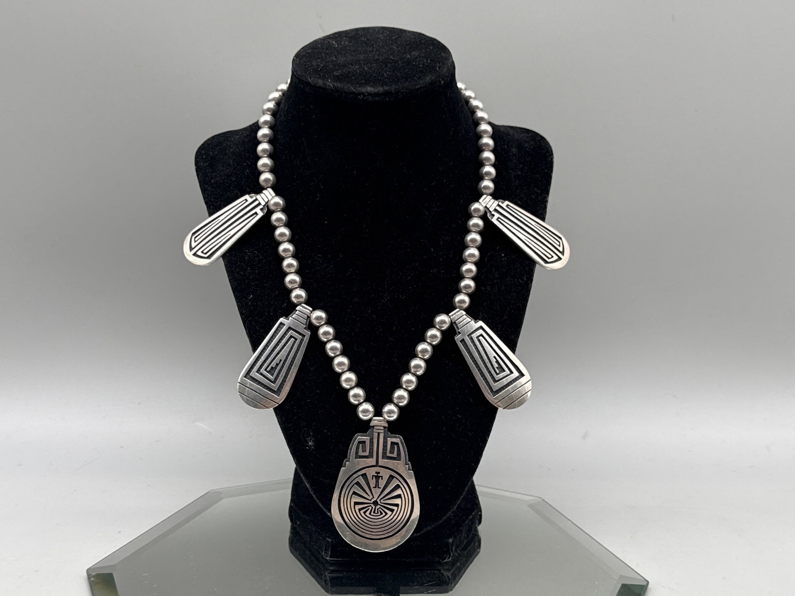 Navajo Sterling Silver Pendant Necklace: A Navajo sterling silver pendant necklace with "Man in the Maze" naja. Hallmarked and marked Sterling. Naja: 2in tall x 2in wide. Necklace: 18in long. 55.49 dwt. | You have additional shipping