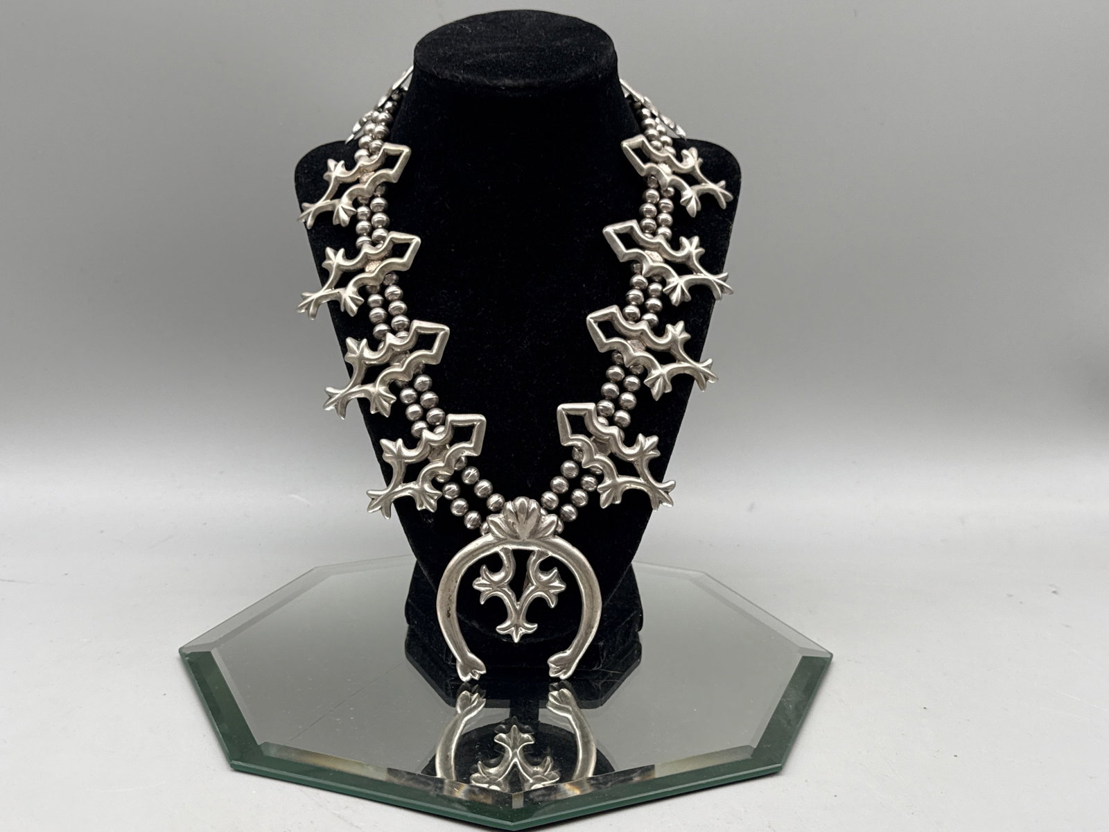 Navajo Silver Squash Blossom Necklace: A Navajo silver squash blossom necklace with silver beads and prominent naja pendant. Naja: 2in tall x 2in wide. Necklace: 24in long. 128.79 dwt. | You have additional shipping options, and are not