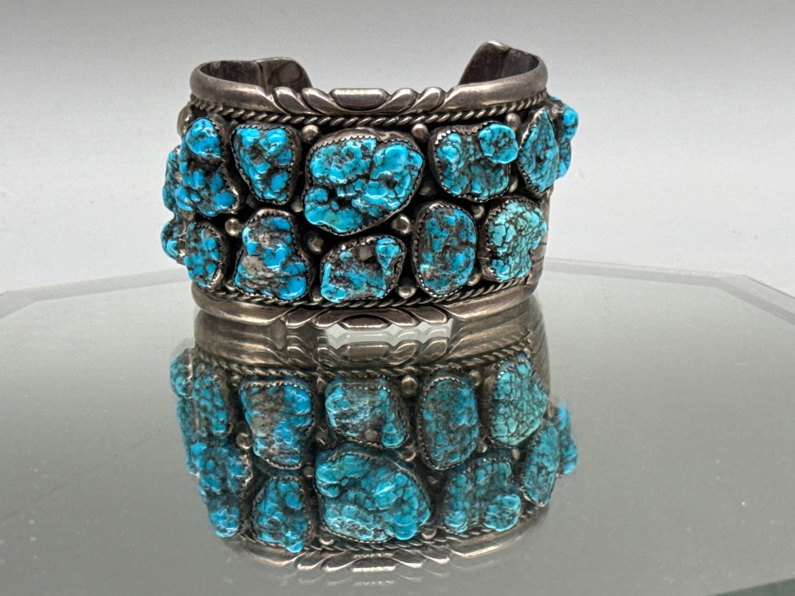 Zuni Silver and Turquoise Cuff Bracelet: A Zuni silver cuff bracelet with 15 large turquoise stones. Signed Zuni EMY. 2in tall x 3in wide. 109.57 dwt. | You have additional shipping options, and are not required to use Live Shipping.