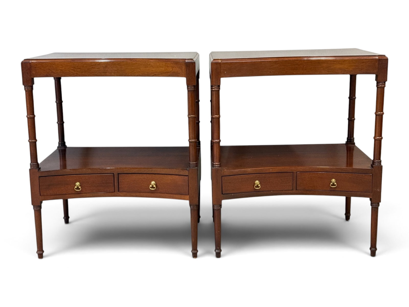 Pair of Regency-style Mahogany Bedside Tables: A pair of Regency-style mahogany bedside tables of concave form, with turned legs and two small drawers. 27in tall x 22in wide x 16in deep. | You have additional shipping options, and are not