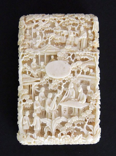 Chinese Antique Ivory Card Case: Chinese ornately-carved antique ivory card case, depicting figures with trees and flowers. 4-1/8” x 2-1/2” x 3/4”.