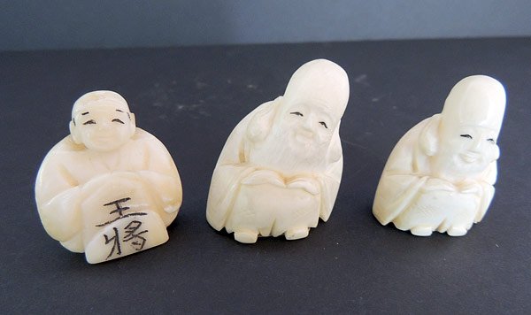 Three Antique Ivory Netsukes: Lot of three antique carved ivory netsukes: seated men. Tallest is 1-3/4”.
