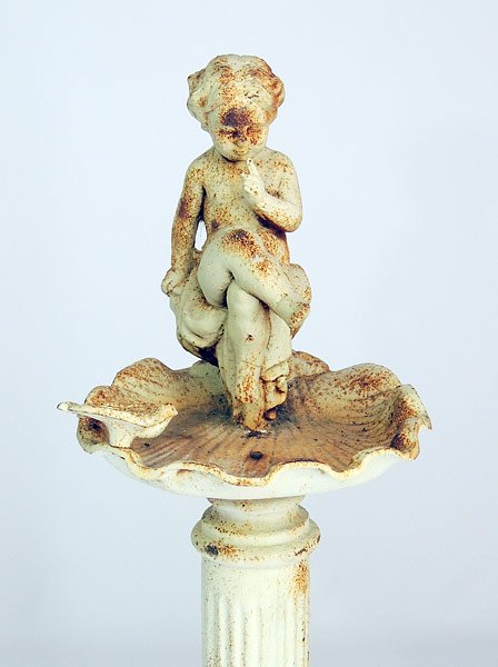 Cast Iron Cherub and Bird Birdbath: Painted cast iron cherub and bird figural birdbath on column base. 38” tall, 12-1/2” wide, 13” deep.