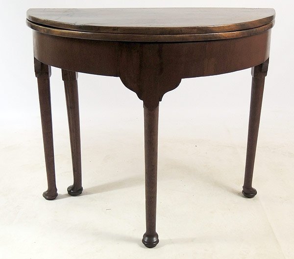 George I Demilune Games Table: Early 18th C/George I walnut demilune games table with single gate-leg and a D-shaped top, opening to a well with carved holes for pieces. 29-1/2" tall, 34-1/2" wide, 17" deep.