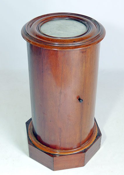 Continental Empire Pot Cupboard: Continental (possibly English) Empire mahogany pot cupboard with a cylindrical form and inset marble top, on an octagonal base. 29” tall, x 14” diameter.