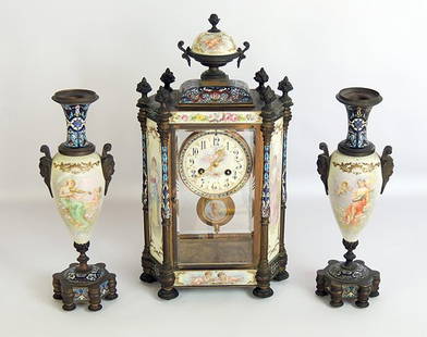 Tiffany & Co. French Garniture Set: Late 19th C. French Tiffany & Co. three-piece porcelain and enamel garniture set comprising a mantle clock in hexagonal case with two porcelain side panels, urn-form finial, and dial inscribed “Tiff