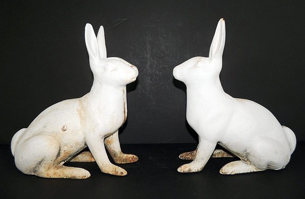 Cast Iron Rabbits: Pair of white-painted cast iron seated rabbits. 12” tall, 9” long.