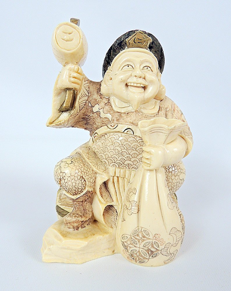 Antique Chinese Carved and Painted Ivory: Antique Chinese carved and painted seated man holding a hammer and a sack, colored in black, red, and gold. 6" tall.