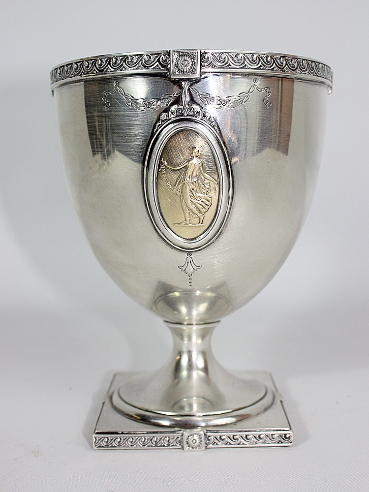 Sterling Cup: Sterling cup on footed base with a figural panel and monogrammed reverse. Marked "Pompeiian", "Sterling", "N186" and hallmarked on base. 6-3/4" tall x 5-1/2" diameter. 19.40 ozt.