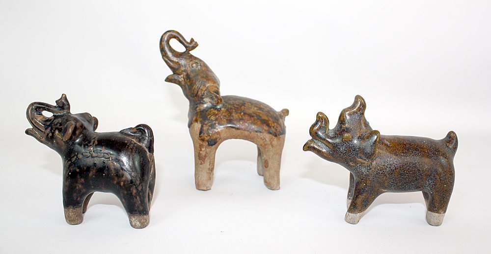 Three Southeast Asian Glazed Pottery Animals: Grouping of Three Southeast Asian Glazed Pottery Animals: Large standing elephant (5-1/4" tall); Rhinoceros (3-1/2" tall); Elephant (3-1/2" tall), with Mathais Komor Gallery sticker on underside.