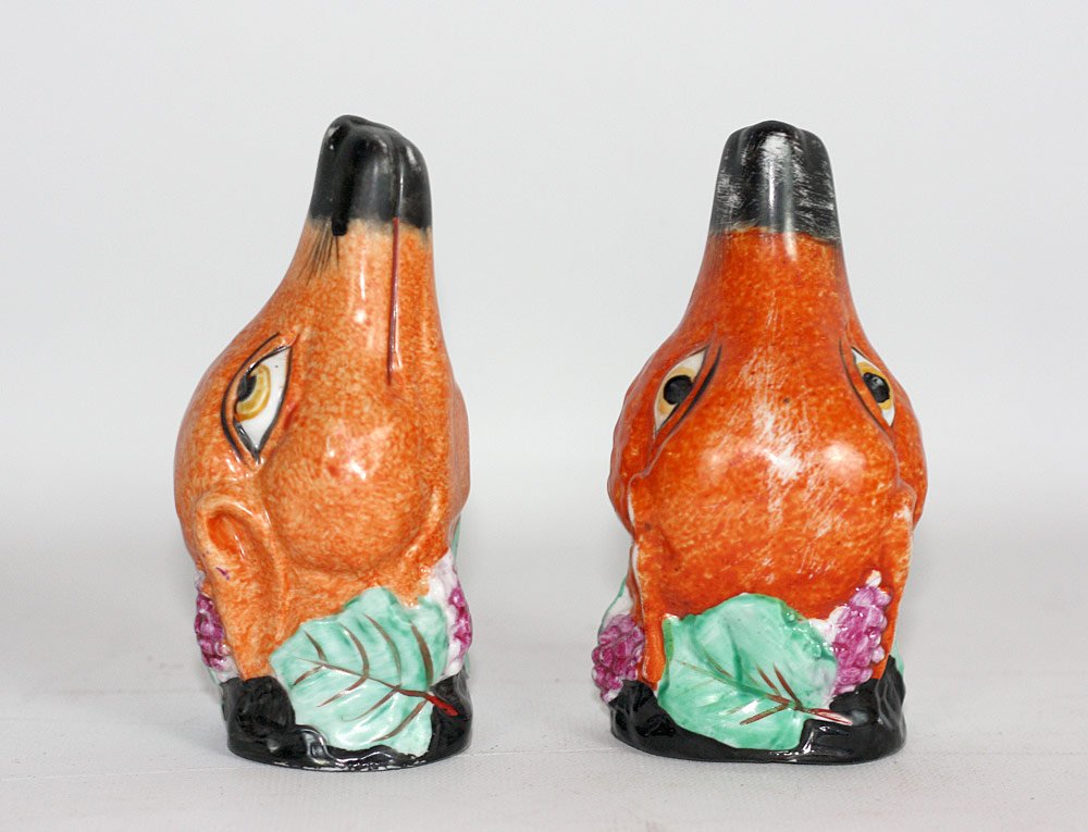 Two Staffordshire Fox-head Stirrup Cups: Two Staffordshire fox head stirrup cups with grape bunch decoration. 5" tall.